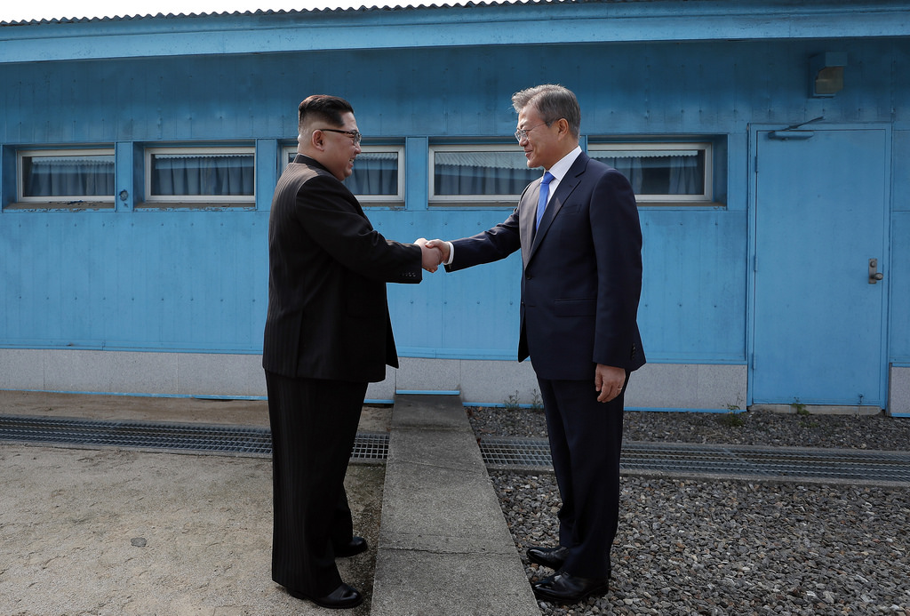 President Moon Jae-in greets Kim Jong-un, the leader of North Korea, at the border between the two countries.