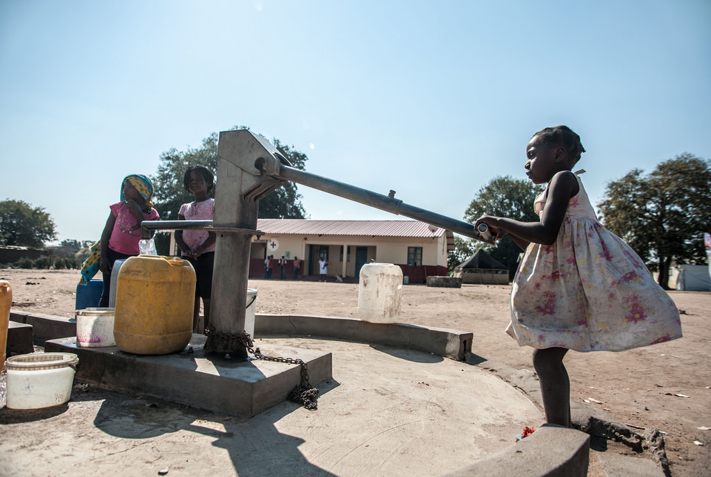 Children pump water in Mozambique.