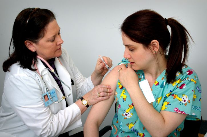 A woman being vaccinated.