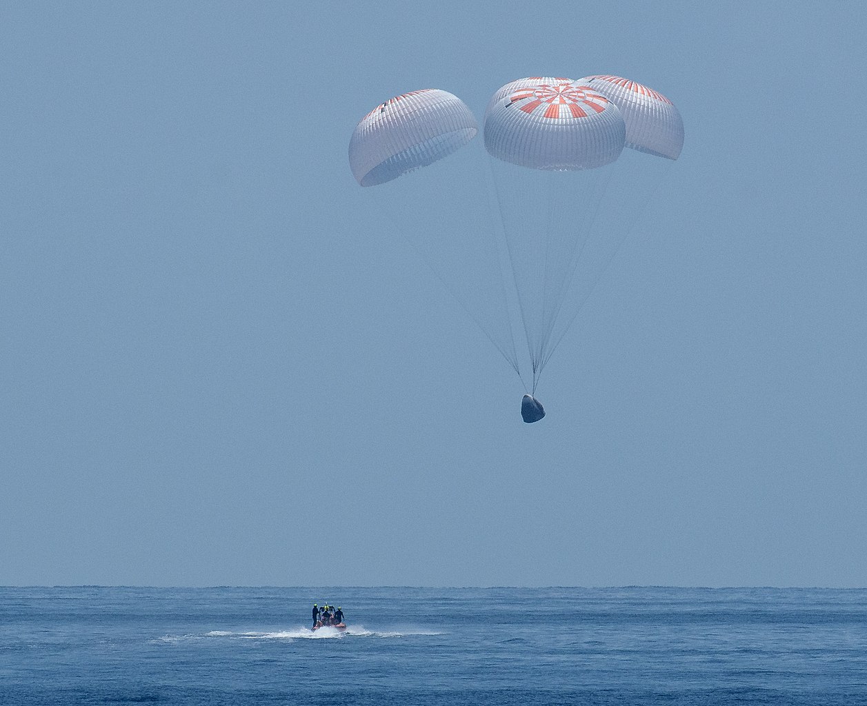 The SpaceX Crew Dragon Endeavour spacecraft is seen as it lands with NASA astronauts Robert Behnken and Douglas Hurley onboard in the Gulf of Mexico off the coast of Pensacola, Florida, Sunday, Aug. 2, 2020.