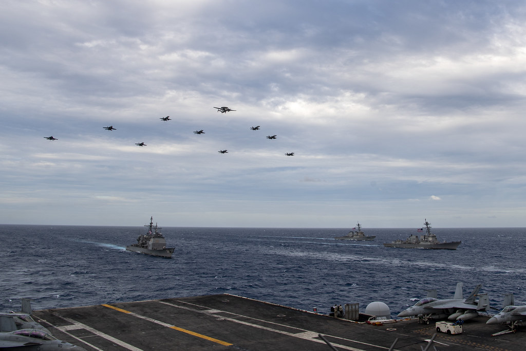 Aircraft assigned to Carrier Air Wing (CVW) 17 fly over the Theodore Roosevelt Carrier Strike Group and the Nimitz Carrier Strike Group in the South China Sea Feb. 9, 2021.