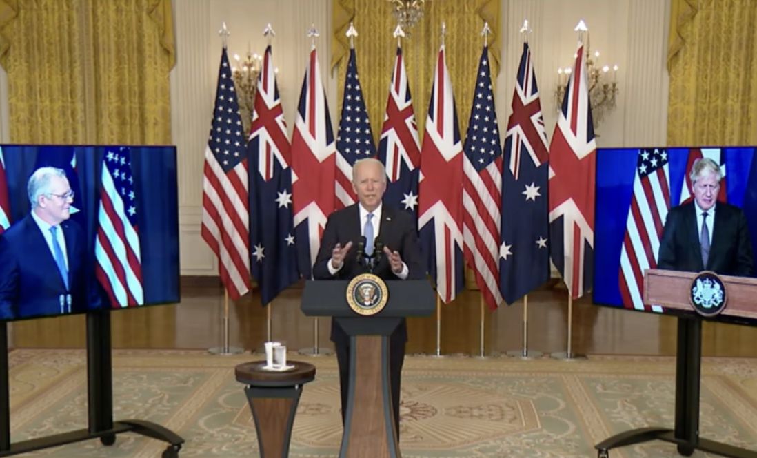 US President Joe Biden speaking about the AUKUS agreement, with Australian Prime Minister Scott Morrison (left) and UK Prime Minister Boris Johnson (right) on video screens.