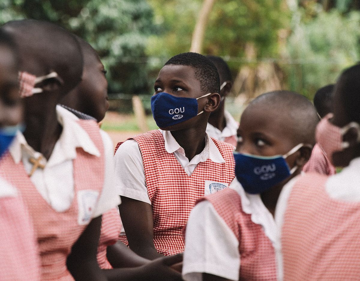 Students in Uganda study outside in February, 2021.