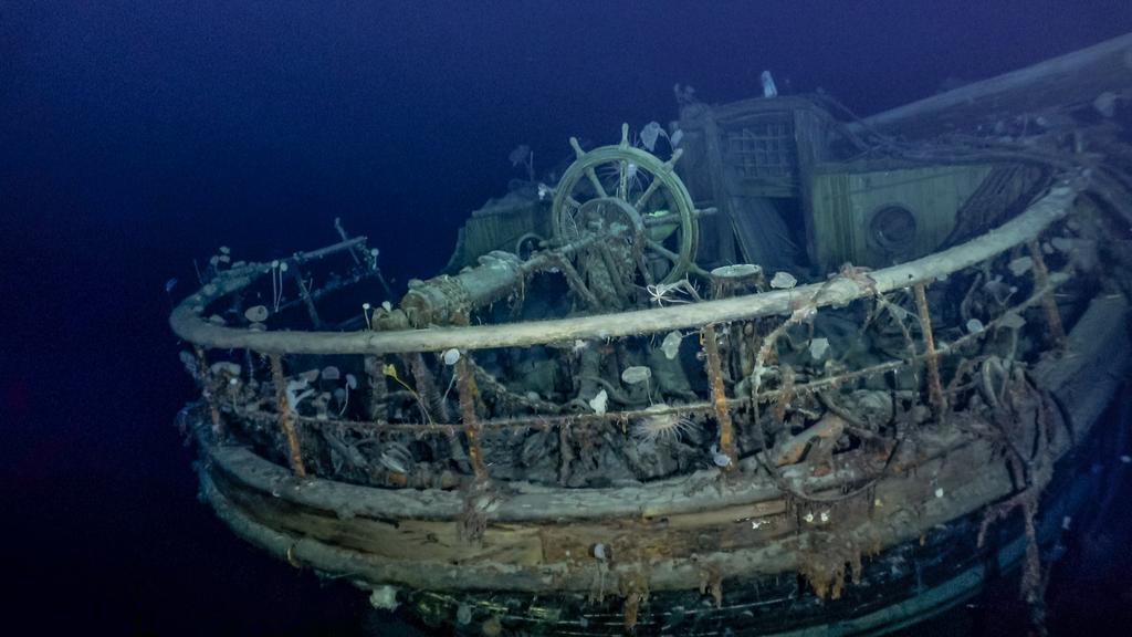 The helm of the Endurance showing the wheel and the railing.