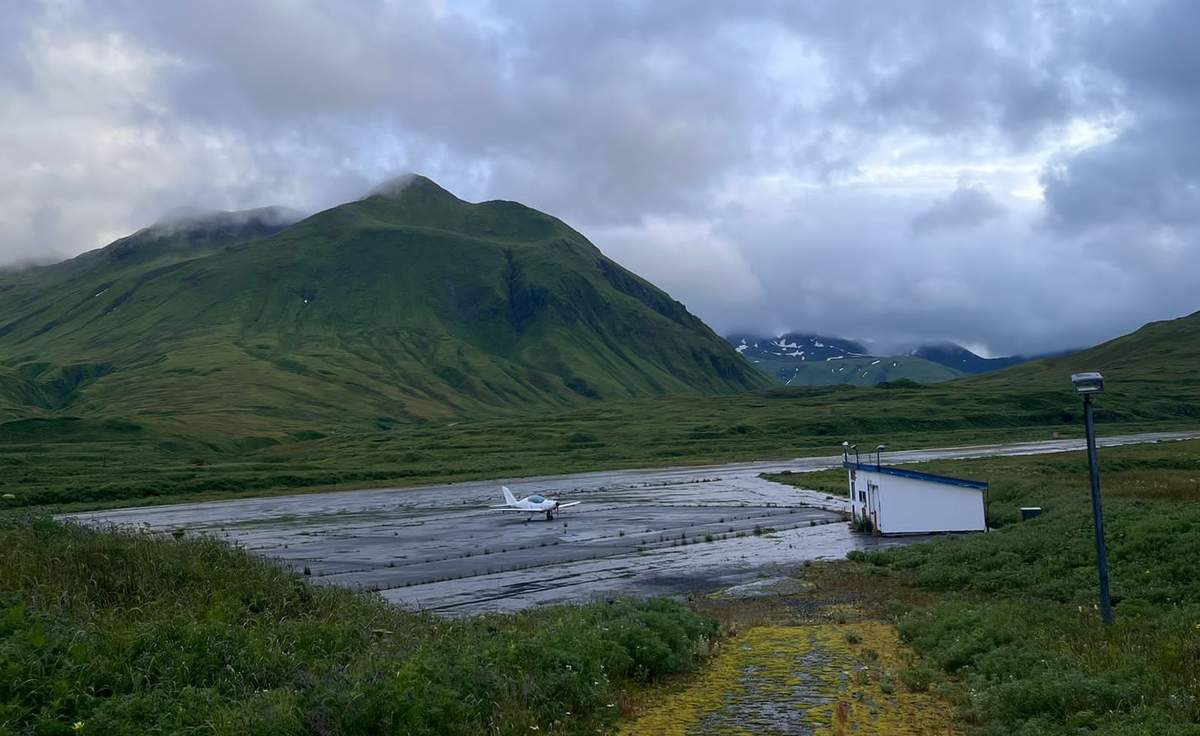 Crossing the Pacific Ocean was the most difficult part of the trip. After a 10-hour flight from Japan, he had to land - just as it was getting dark - on an island with no one else on it. He spent the night in an old shed beside the runway. Above, the plane on the island runway the next morning.