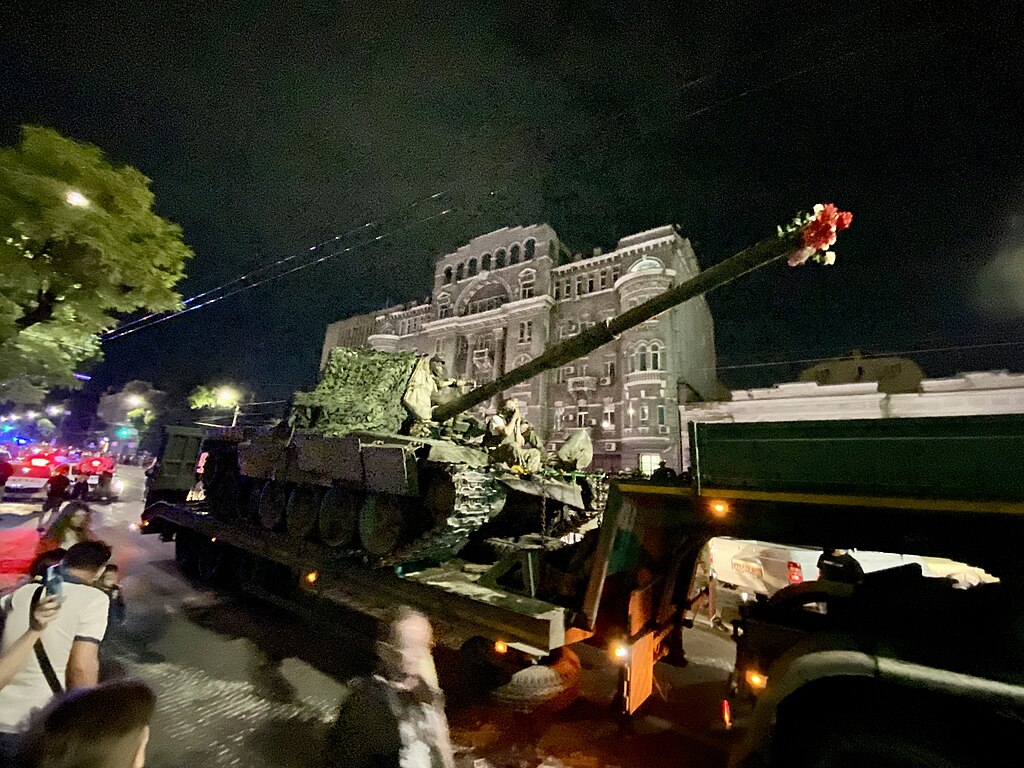 A nighttime image of a Wagner PMCS tank with flowers in the muzzle in Rostov-on-Don after the end of the Wagner Group rebellion in Russia.