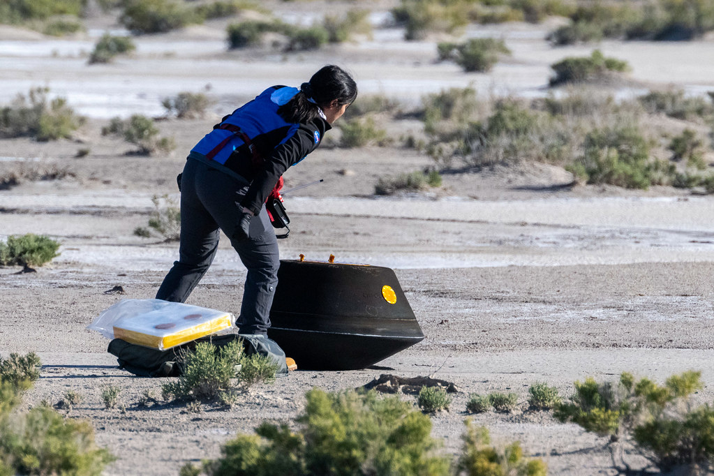 Lockheed Martin System Safety Engineer Victoria Thiem performs preliminary checks on the sample return capsule from NASA’s OSIRIS-REx mission, Sunday, Sept. 24, 2023, shortly after the capsule landed at the Department of Defense's Utah Test and Training Range. The sample was collected from the asteroid Bennu in October 2020 by NASA’s OSIRIS-REx spacecraft.