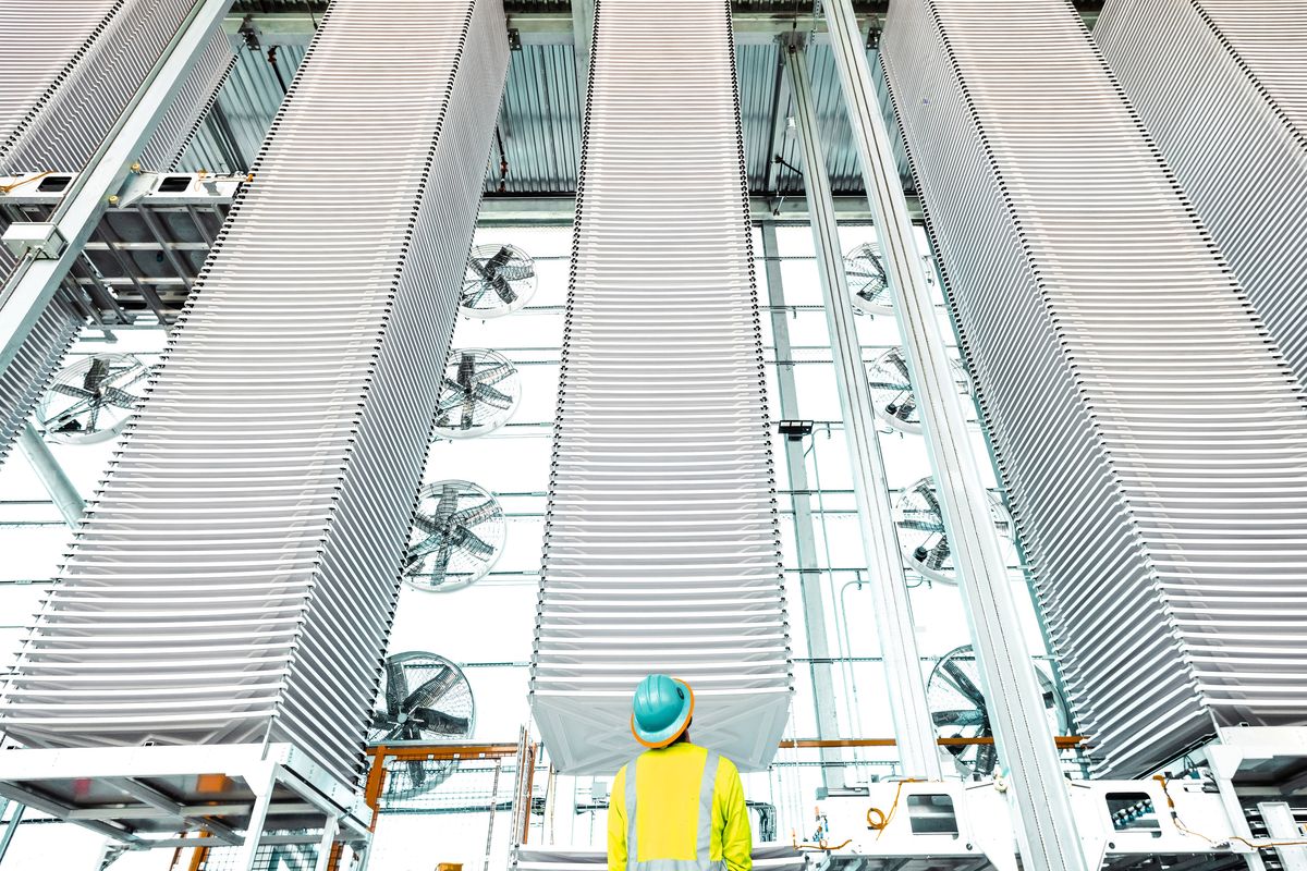 A worker stands in front of Heirloom's Direct Air Capture plant.