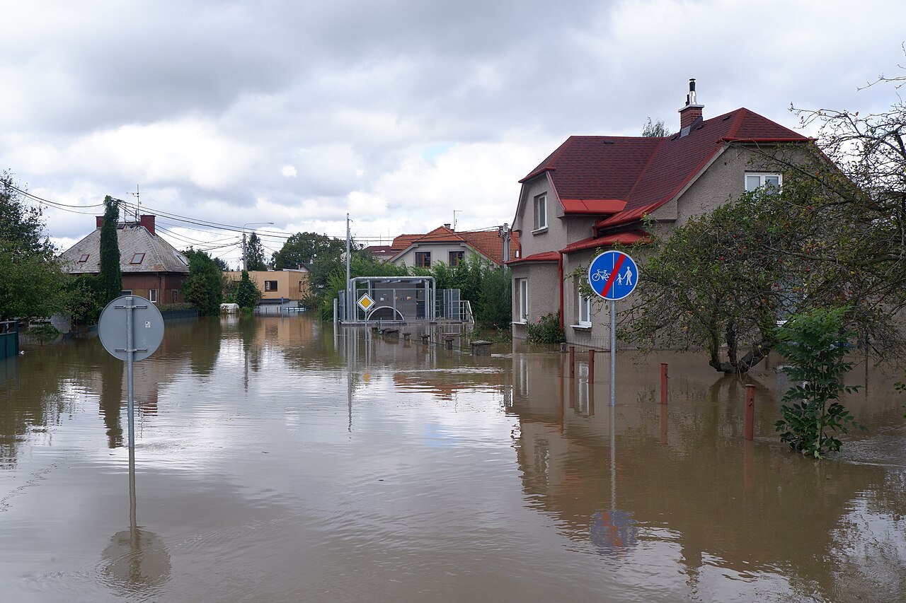 September 2024 floods in Ostrava, Czech Republic. Houses and street signs are visible, but roads, sidewalks, and lawns appear to be under about two feet of water.