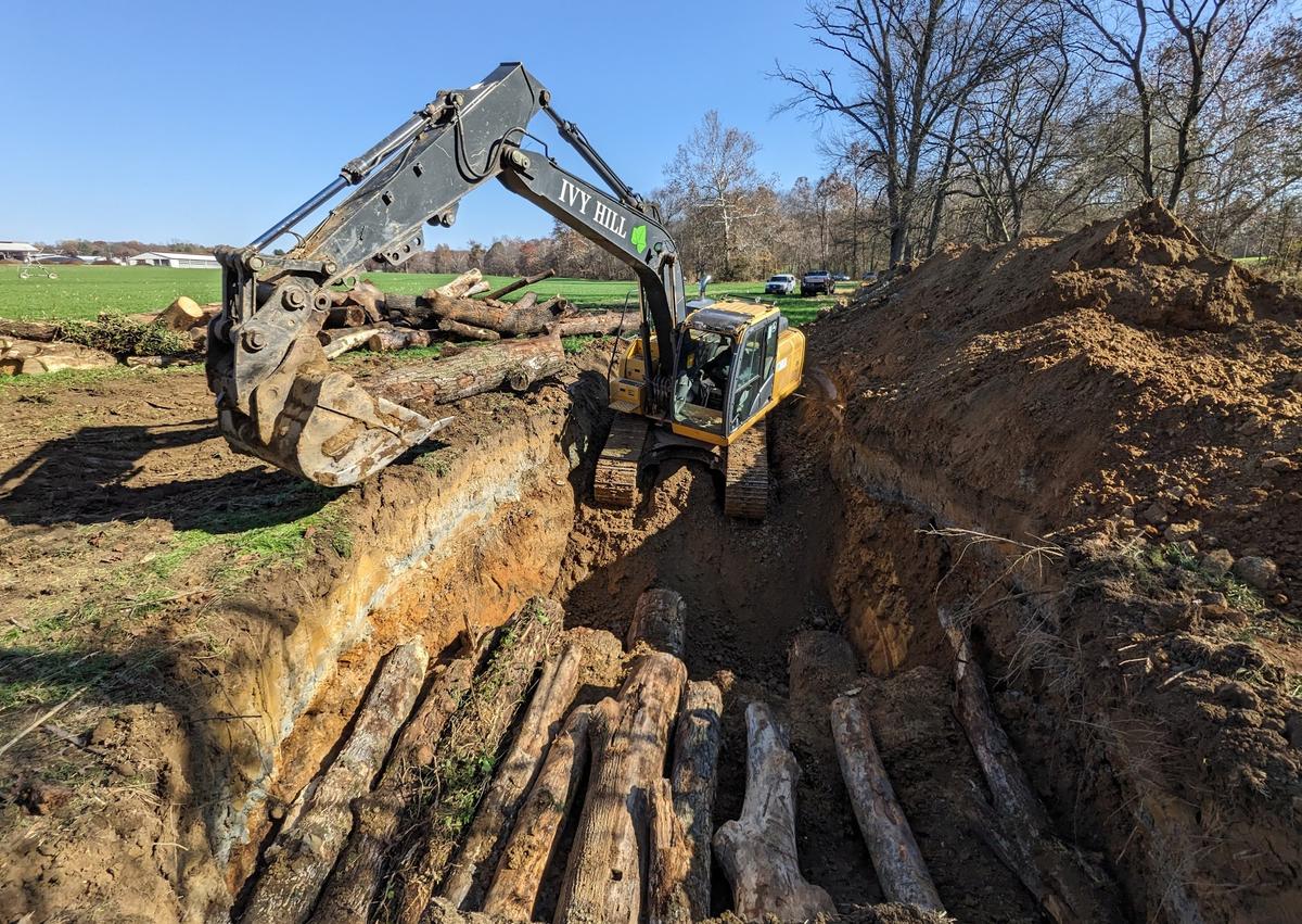 Above, a 2023 wood vaulting project led by Dr. Zeng. The wood being buried wasn't cut down for the project. It was waste wood that was going to shredded into mulch. If not for the wood vaulting, the carbon stored in this wood would have been released.