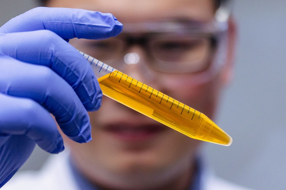 Dr. Zihao Ou, assistant professor of physics at UT Dallas, holds a vial of the common yellow food coloring tartrazine in solution. In an article published online Sept. 5 in Science, Ou and his colleagues report that they safely made the skin of live mice transparent by applying the dye solution. The process is reversible.