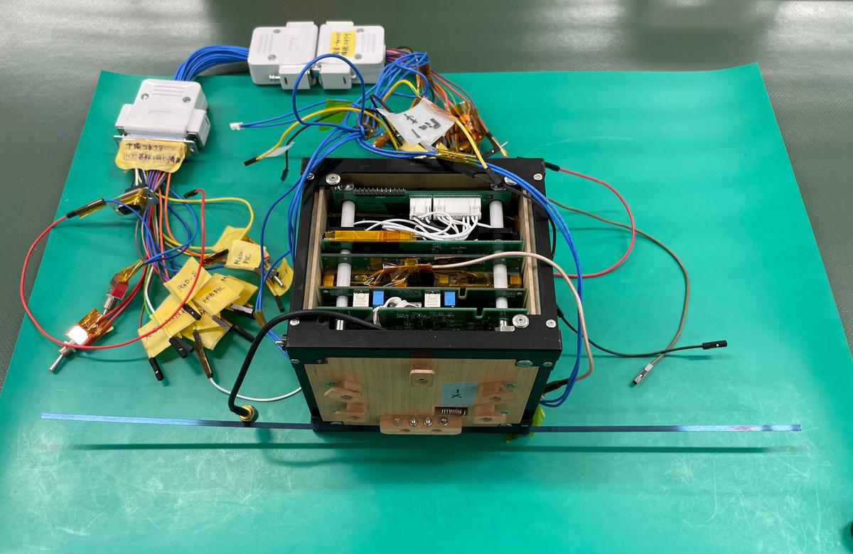 The electronics and sensors inside the LignoSat being tested.